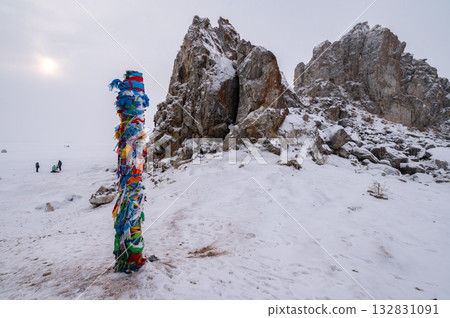 The Shaman pole in front of the Shaman rock one of sacred place in frozen lake Baikal in winter season of Siberia, Russia. 132831091