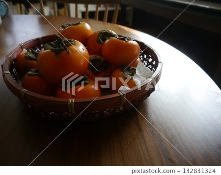 A basket full of persimmons 132831324
