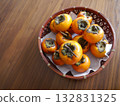 A basket filled with persimmons 132831325