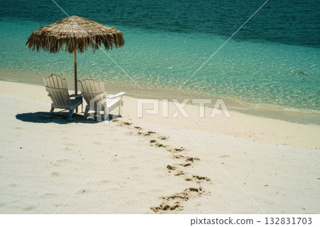 Relaxing Beach Chairs Under Straw Umbrella with Tranquil Water and Sandy Shoreline 132831703
