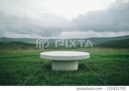 Large White Pedestal Table in a Minimalist Green Landscape Under Dramatic Cloudy Sky Large White Pedestal Table in a Minimalist Green Landscape Under Dramatic Cloudy Sky 132831792