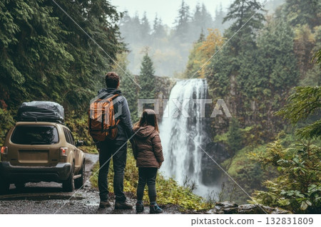 Scenic Family View Overlooking Waterfall in Lush Greenery with Vehicle Nearby 132831809