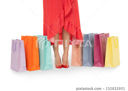 Woman stands confidently beside colorful shopping bags, on white, PNG 132832931