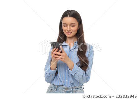 Woman enjoys using her smartphone while standing and smiling, PNG Woman enjoys using her smartphone while standing and smiling, PNG 132832949