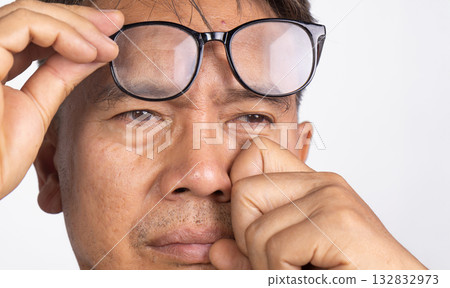 Senior man eye strain after for long stretches at digital screens. 132832973