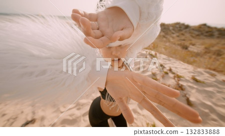 A Stunning and Dramatic Fashion Moment at the Beach Featuring Flowing White Feathers A Stunning and Dramatic Fashion Moment at the Beach Featuring Flowing White Feathers 132833888