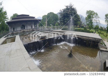 The buildings and ponds that decorate the Shalimar Bagh Gardens are a beautiful Mughal garden in Srinagar, Jammu and Kashmir, India. The gardens are decorated with fountains, ponds and plants. 132834442