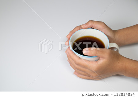 Close-up of hands with hot coffee 132834854
