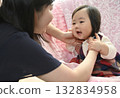 Baby playing with mom 132834958