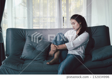 Sorrowful woman sat alone, overwhelmed by emotion, her sad and unhappy expression revealing deep despair, stress and distress left feeling depressed. sorrowful sad, despair alone, depressed stress Sorrowful woman sat alone, overwhelmed by emotion, her sad and unhappy expression revealing deep despair, stress and distress left feeling depressed. sorrowful sad, despair alone, depressed stress 132834996