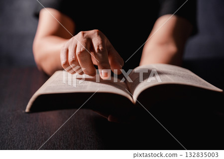 Bible in hand, christian lifts prayer in worship, holding firmly to holy concept of faith, hope and deep belief guides their spiritual life. Hands together in prayer to God along with bible Bible in hand, christian lifts prayer in worship, holding firmly to holy concept of faith, hope and deep belief guides their spiritual life. Hands together in prayer to God along with bible 132835003