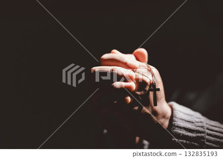 Person clasping hands in prayer, symbolizing faith, hope, spirituality, devotion, inner strength, meditation, belief, healing and the power of trust during difficult times in life. Person clasping hands in prayer, symbolizing faith, hope, spirituality, devotion, inner strength, meditation, belief, healing and the power of trust during difficult times in life. 132835193