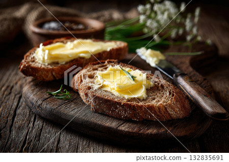 Freshly melted butter on homemade bread with rustic knife 132835691