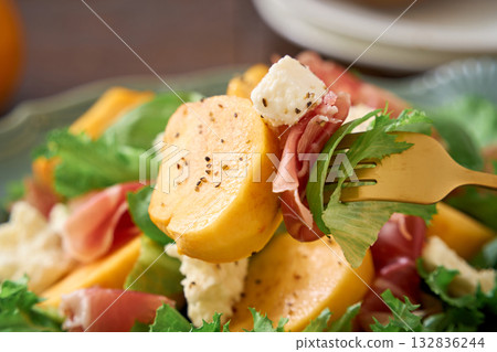 Autumnal salad of persimmon, prosciutto and cottage cheese Autumnal salad of persimmon, prosciutto and cottage cheese 132836244