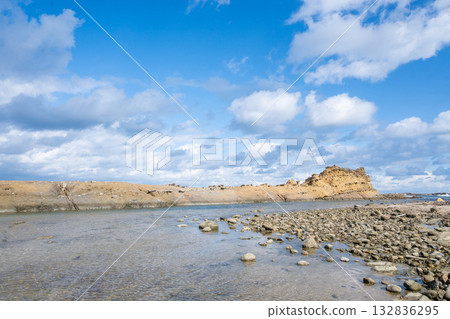 A walk through Senjojiki in Shimane Prefecture on a clear day. Irregularly shaped rocks scattered along the coast. The rough waters of the Sea of Japan. 132836295