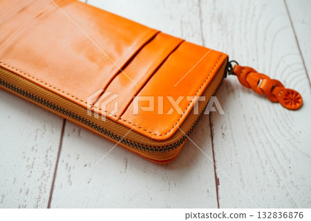 Orange leather wallet with a bright and elegant texture and design Orange leather wallet with a bright and elegant texture and design 132836876