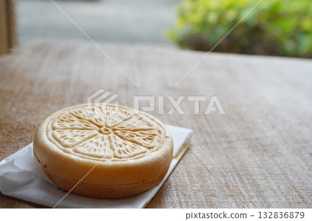 Citrus-patterned monaka placed on a wooden table - an elegant Japanese sweet Citrus-patterned monaka placed on a wooden table - an elegant Japanese sweet 132836879