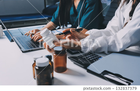 Group of doctors attending seminar in hospital lecture hall with senior physician giving medical presentation and professional training session on healthcare practices 132837379