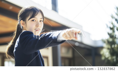 Asian high school girl in uniform pointing with a smile 132837862
