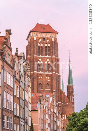 St. Mary's Church in Gdansk, a city on the Baltic coast of northern Poland, Europe. Iconic brick architecture frames a serene cityscape, blending history with a tranquil urban setting. 132838540