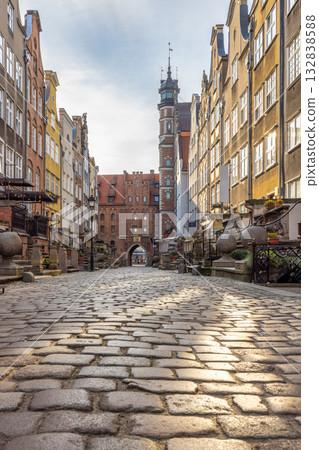 Mariacka street in Gdansk city on the Baltic coast of northern Poland, Europe. Cobblestone streetscape with historic buildings, stairs, and a church in the distance. 132838588