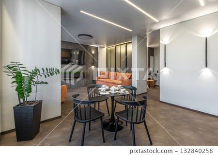 Modern Living Room with Orange Sofa and Black Dining Set Modern Living Room with Orange Sofa and Black Dining Set 132840258