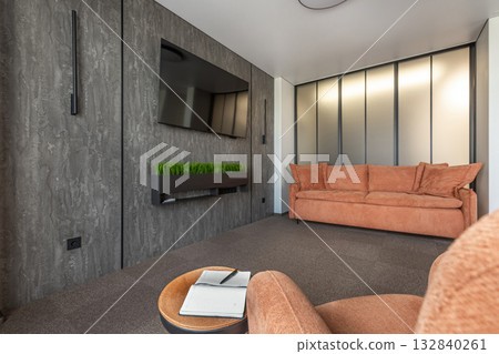 Modern Living Room with Orange Sofa and Textured Gray Wall 132840261
