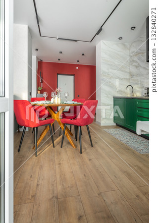 Bright Modern Kitchen and Dining Area with Red Chairs Bright Modern Kitchen and Dining Area with Red Chairs 132840271