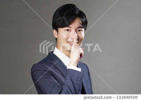 Businessman secret pose black background 132840500