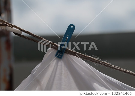 Drying white T-shirts and clothespins: an everyday scene 132841405