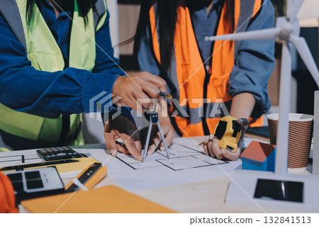 Architects and engineers working collaboratively on construction project 132841513