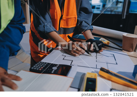 Architects and engineers working collaboratively on construction project Architects and engineers working collaboratively on construction project 132841521