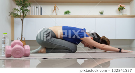 Yoga and Mindfulness. Young woman practicing child pose at home. 132841557