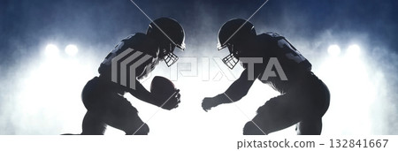 American football players in dynamic formation with misty background 132841667