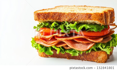 Delicious layers of fresh ham, crisp lettuce, and ripe tomato stacked between slices of whole grain bread, ready to enjoy at lunchtime Delicious layers of fresh ham, crisp lettuce, and ripe tomato stacked between slices of whole grain bread, ready to enjoy at lunchtime 132841801
