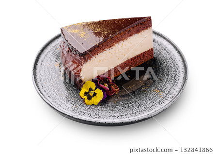 Delicious chocolate cake slice served on a decorative plate with flowers 132841866