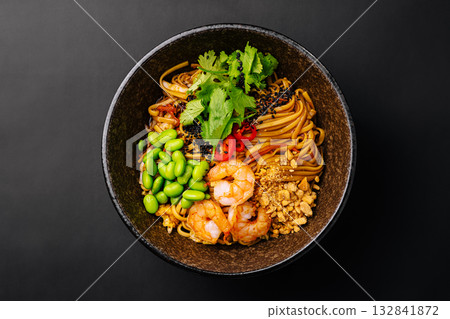 Delicious shrimp noodles served with fresh vegetables and herbs Delicious shrimp noodles served with fresh vegetables and herbs 132841872