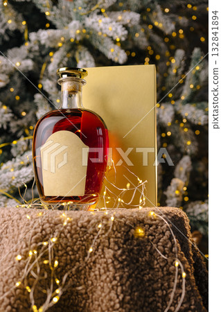 Elegant bottle of red liquid on a festive table during winter holiday season 132841894