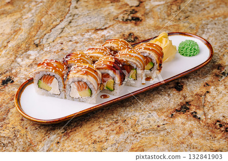 Delicious sushi platter served on a stylish plate in a cozy restaurant setting 132841903