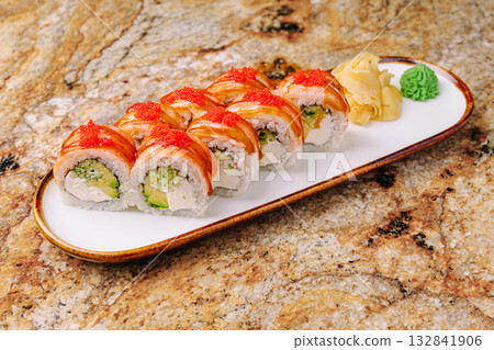 Fresh sushi rolls with avocado and salmon on a marble table 132841906