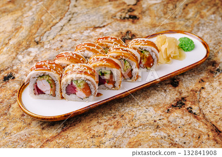 Delicious sushi rolls on a white plate with ginger and wasabi 132841908