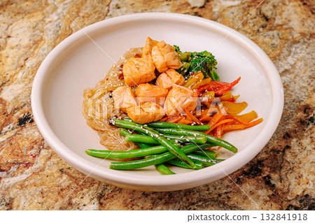 Salmon bowl with noodles and veggies on a stone countertop Salmon bowl with noodles and veggies on a stone countertop 132841918