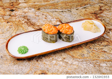Fresh sushi served on a white plate with wasabi and pickled ginger Fresh sushi served on a white plate with wasabi and pickled ginger 132841933