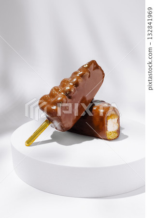 Delicious chocolate-covered ice cream bars on a sleek white surface Delicious chocolate-covered ice cream bars on a sleek white surface 132841969