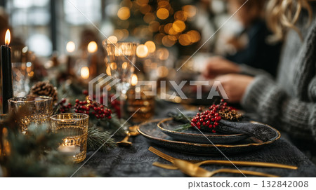 Cozy Christmas dinner table setting with candles and festive decorations 132842008