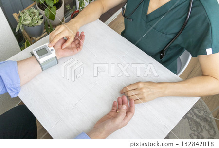 Female doctor measuring blood pressure of the patient Female doctor measuring blood pressure of the patient 132842018