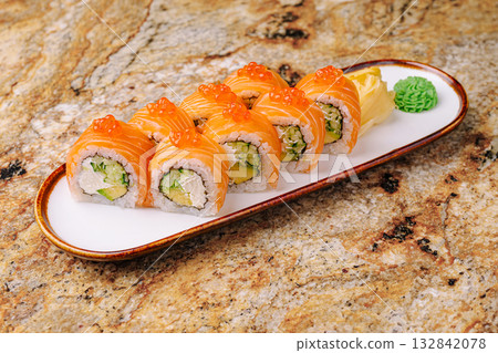 Fresh salmon sushi rolls served on a white plate with wasabi and ginger 132842078