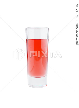 Bright red drink in a clear glass on a white background 132842107