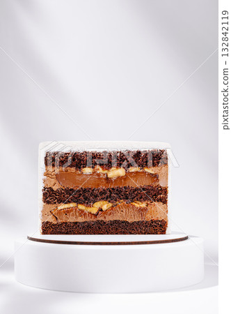 Delicious chocolate cake with layers of cream and fruit on display 132842119