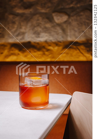 Classic cocktail served on a stylish table with warm lighting 132842125